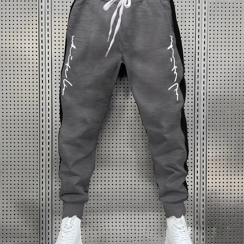 Men's Color Blocked Drawstring Sports Pants with Eye-catching Print Design.