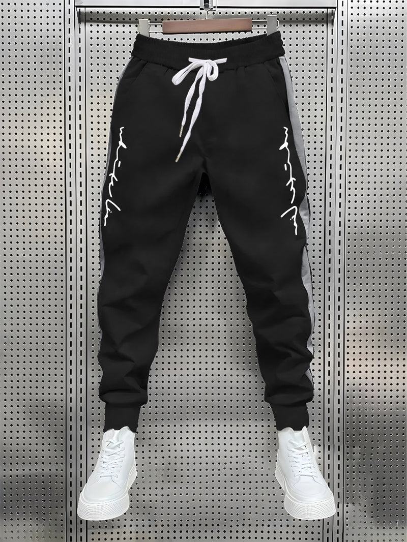 Men's Color Blocked Drawstring Sports Pants with Eye-catching Print Design.