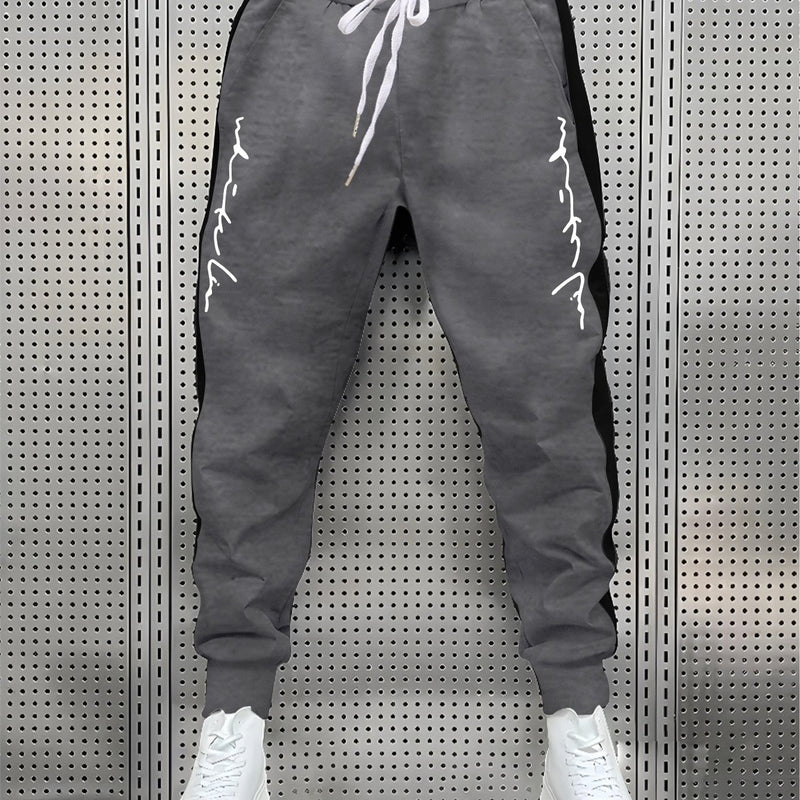 Men's Color Blocked Drawstring Sports Pants with Eye-catching Print Design.