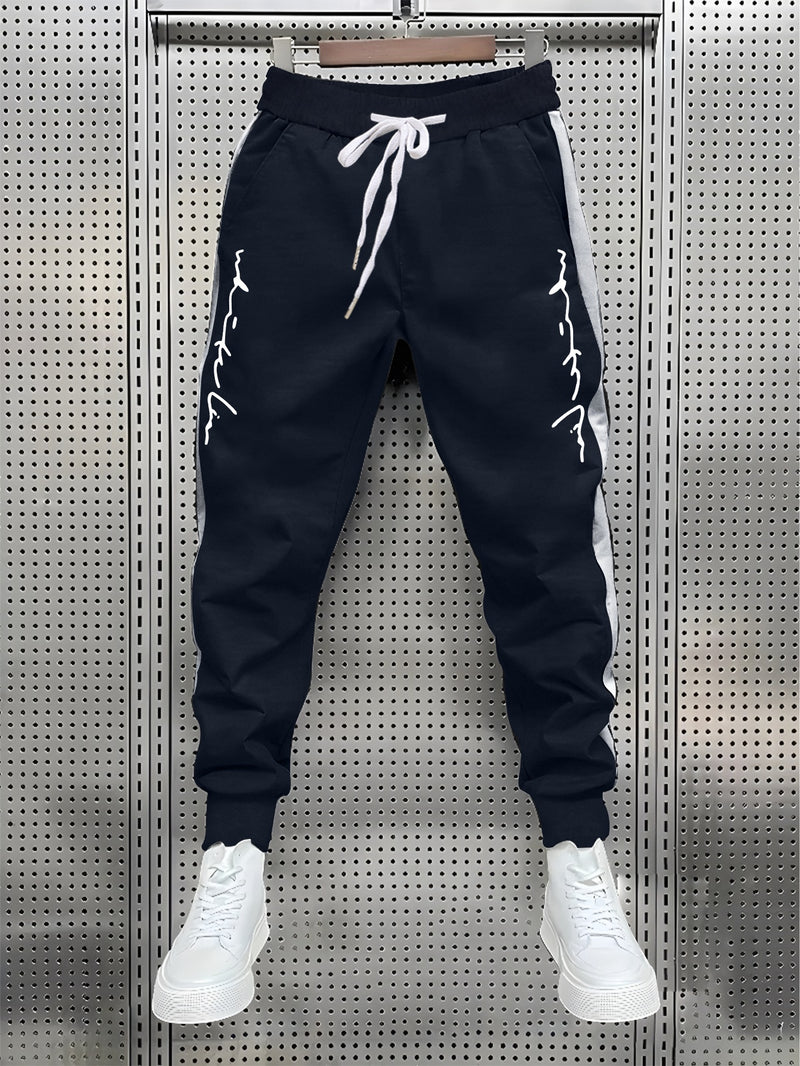 Men's Color Blocked Drawstring Sports Pants with Eye-catching Print Design.