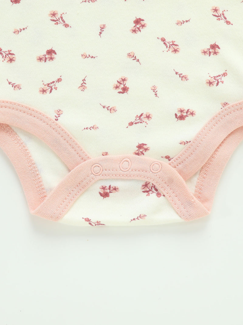 Four-Piece Infant Romper, Long-Sleeve Top, and Footed Pants Set.