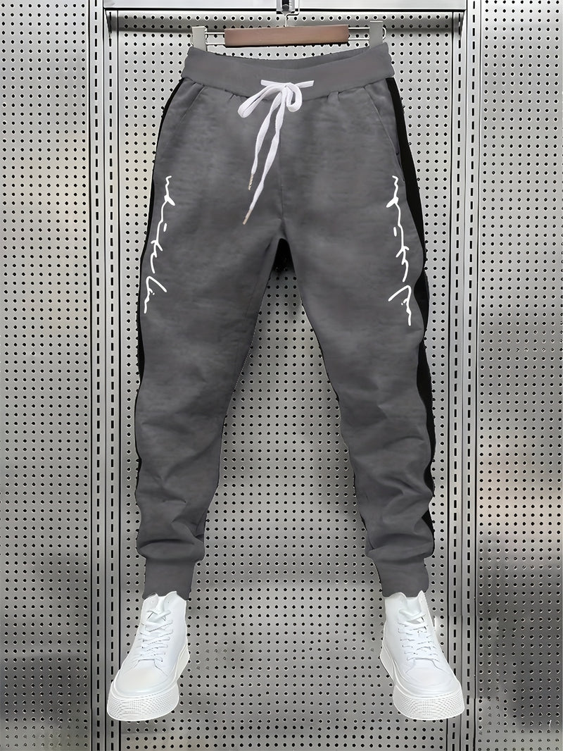 Men's Color Blocked Drawstring Sports Pants with Eye-catching Print Design.