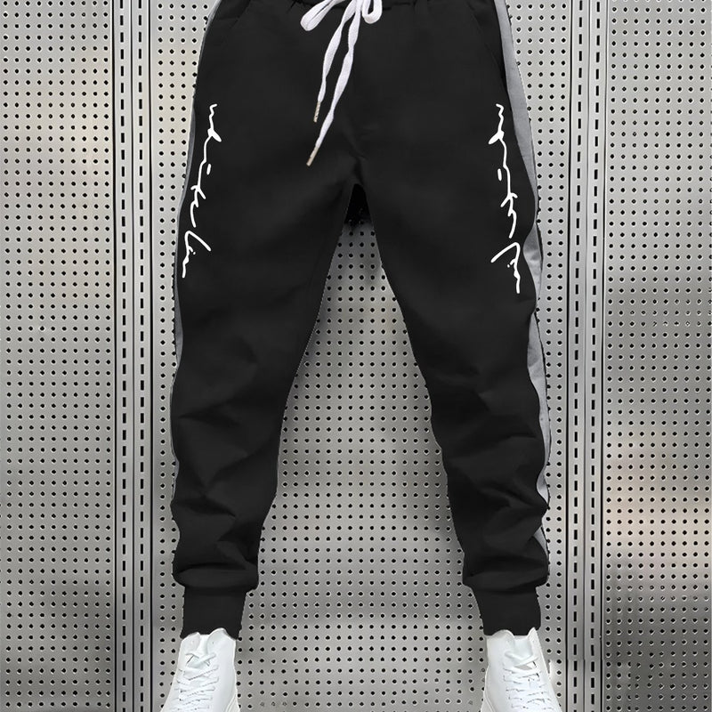 Men's Color Blocked Drawstring Sports Pants with Eye-catching Print Design.