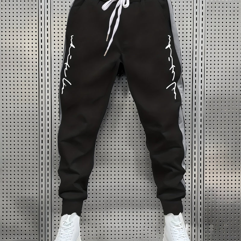 Men's Color Blocked Drawstring Sports Pants with Eye-catching Print Design.