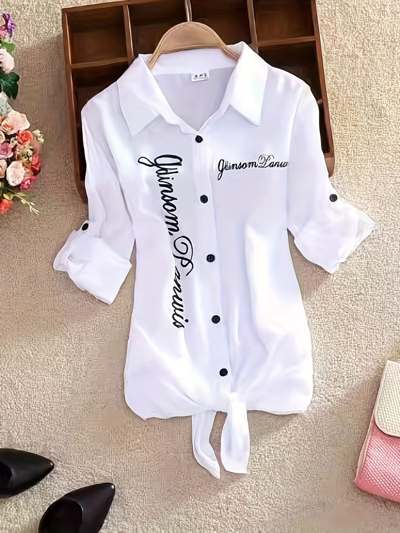 The Lady's Shirt Is White with Black Letters.