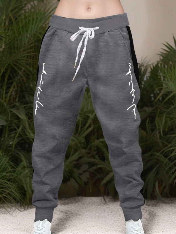 Men's Color Blocked Drawstring Sports Pants with Eye-catching Print Design.